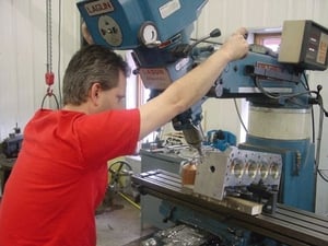 We do a varity of custom machining operations. If you can think it up, we can make it or machine it. This photo shows Marc Shisler working on a head for a competition eliminator project.

