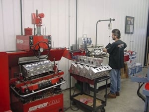 Mark Shisler is shown here preparing the valve guides on a stack of 12° Schmidt Pro-Filer heads. 
