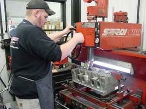 In this picture Lee Latozke is shown working with a set of DRCE II heads. Lee is one of our cylinder head specialist and head porter. Lee has a vast knowledge of Racing Cylinder Head preparation.