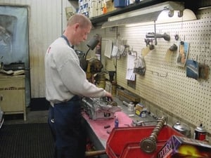 Greg Walford is shown here assembling a over-head cam cylinder head for one of our many automotive customers. 
