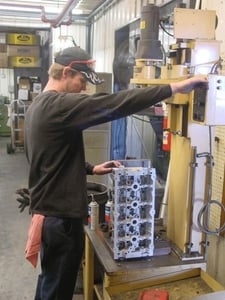 Brad Cain is shown here setting up an over-head cam cylinder head to bore the cam saddles for new cam bearings. 